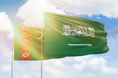 Sunny blue sky and flags of saudi arabia and turkmenistan