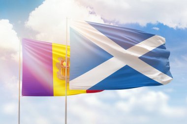 Sunny blue sky and flags of scotland and andorra