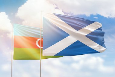 Sunny blue sky and flags of scotland and azerbaijan
