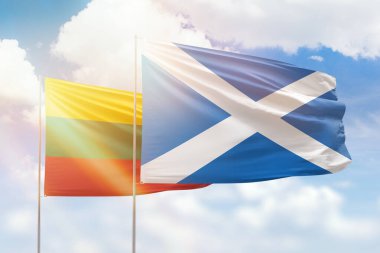 Sunny blue sky and flags of scotland and lithuania