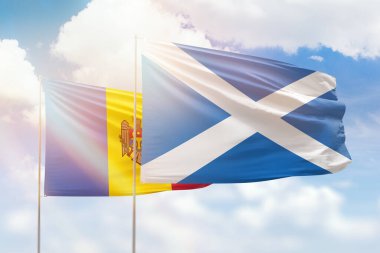 Sunny blue sky and flags of scotland and moldova