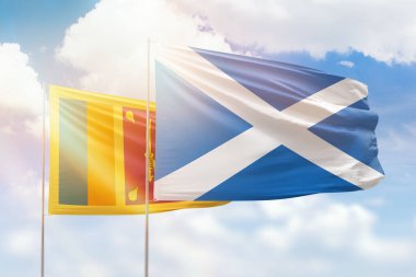 Sunny blue sky and flags of scotland and sri lanka