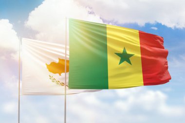Sunny blue sky and flags of senegal and cyprus
