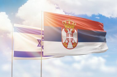 Sunny blue sky and flags of serbia and israel