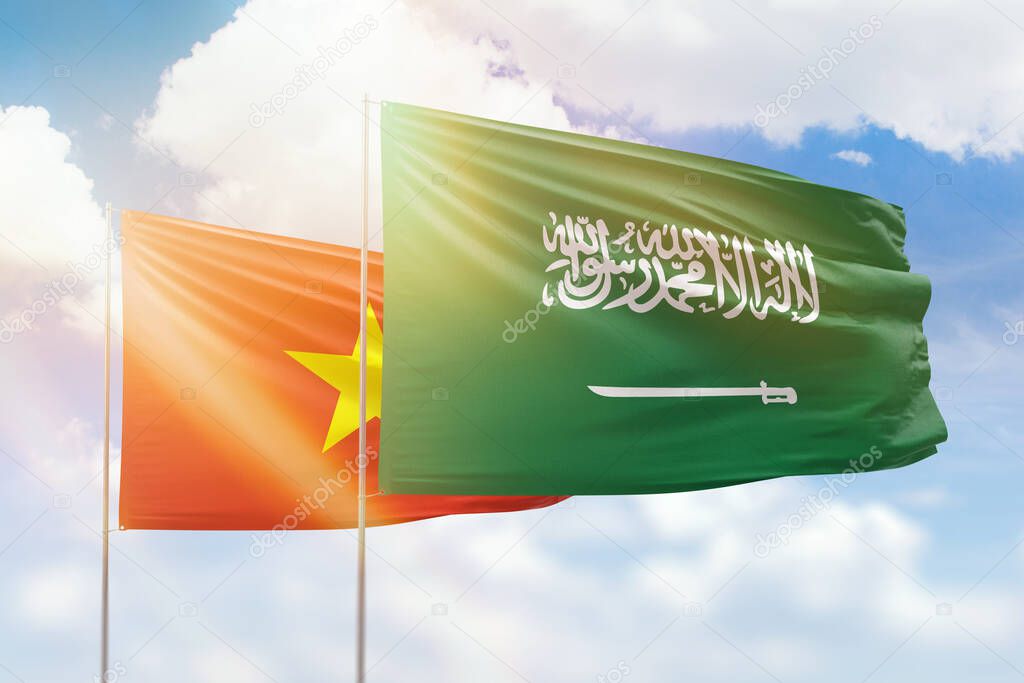 Sunny blue sky and flags of saudi arabia and vietnam
