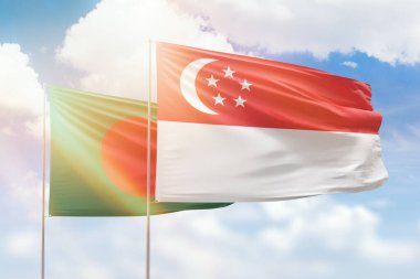 Sunny blue sky and flags of singapore and bangladesh