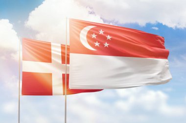 Sunny blue sky and flags of singapore and denmark