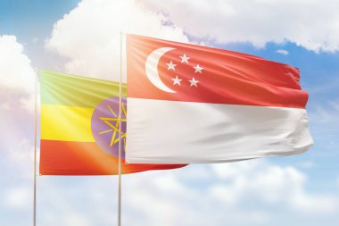 Sunny blue sky and flags of singapore and ethiopia