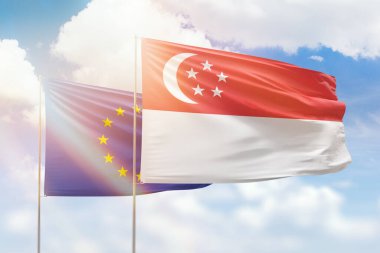 Sunny blue sky and flags of singapore and european union