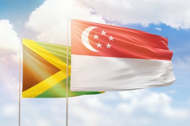 Sunny blue sky and flags of singapore and jamaica