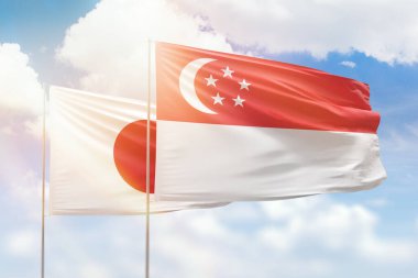 Sunny blue sky and flags of singapore and japan