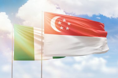 Sunny blue sky and flags of singapore and nigeria