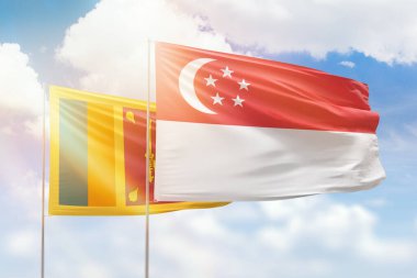 Sunny blue sky and flags of singapore and sri lanka