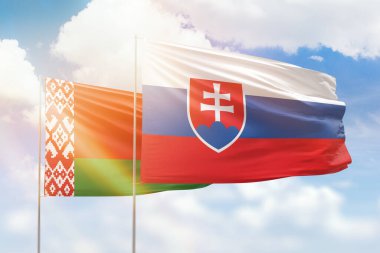 Sunny blue sky and flags of slovakia and belarus