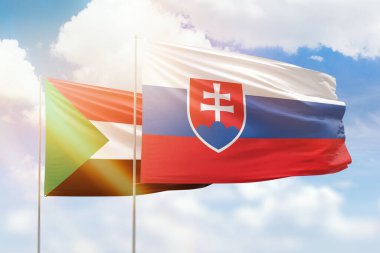 Sunny blue sky and flags of slovakia and sudan