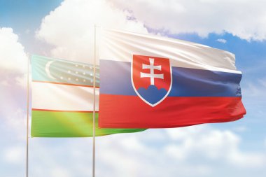 Sunny blue sky and flags of slovakia and uzbekistan