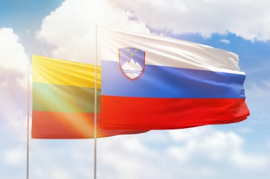 Sunny blue sky and flags of slovenia and lithuania