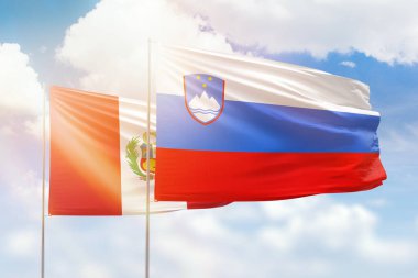 Sunny blue sky and flags of slovenia and peru