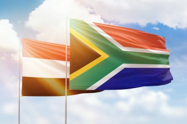 Sunny blue sky and flags of south africa and yemen