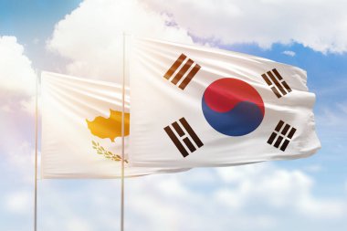 Sunny blue sky and flags of south korea and cyprus