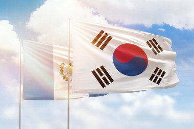 Sunny blue sky and flags of south korea and guatemala