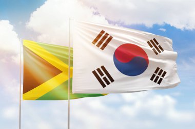 Sunny blue sky and flags of south korea and jamaica