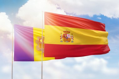 Sunny blue sky and flags of spain and andorra