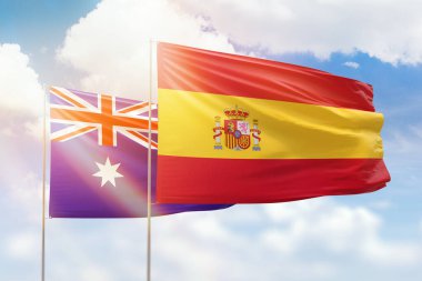 Sunny blue sky and flags of spain and australia