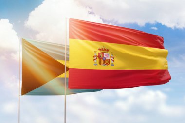 Sunny blue sky and flags of spain and bahamas