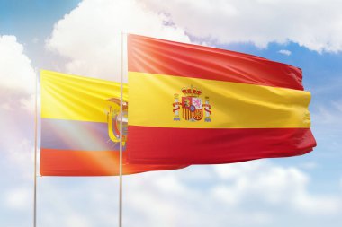 Sunny blue sky and flags of spain and ecuador