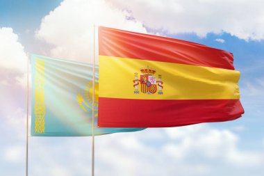 Sunny blue sky and flags of spain and kazakhstan