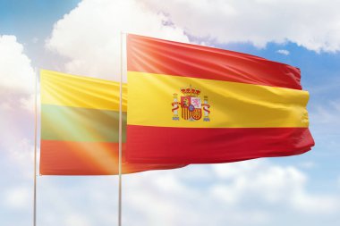 Sunny blue sky and flags of spain and lithuania