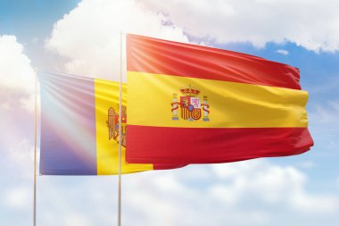 Sunny blue sky and flags of spain and moldova