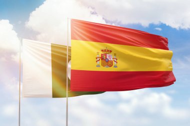 Sunny blue sky and flags of spain and pakistan