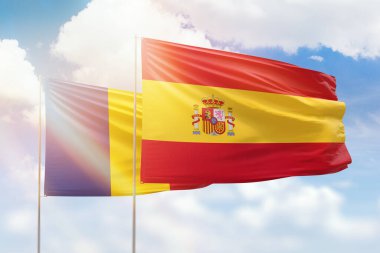 Sunny blue sky and flags of spain and romania