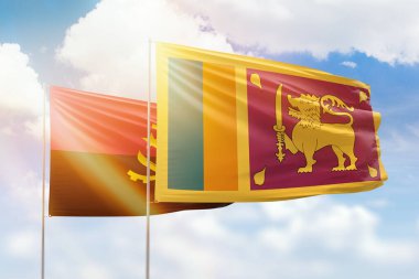 Sunny blue sky and flags of sri lanka and angola