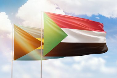 Sunny blue sky and flags of sudan and bahamas