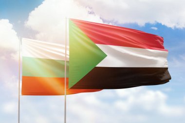 Sunny blue sky and flags of sudan and bulgaria