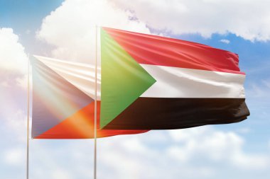 Sunny blue sky and flags of sudan and czechia