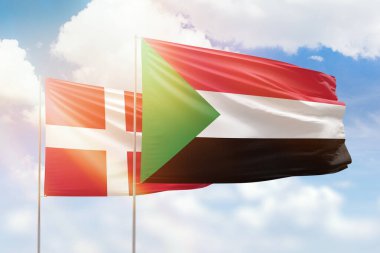 Sunny blue sky and flags of sudan and denmark