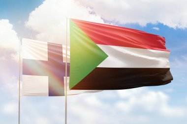 Sunny blue sky and flags of sudan and finland