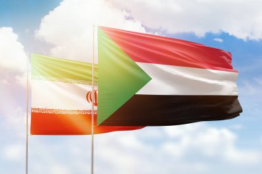 Sunny blue sky and flags of sudan and iran