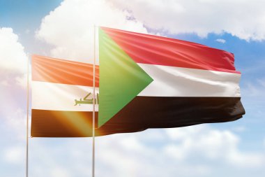 Sunny blue sky and flags of sudan and iraq