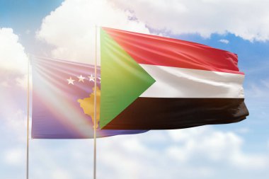 Sunny blue sky and flags of sudan and kosovo
