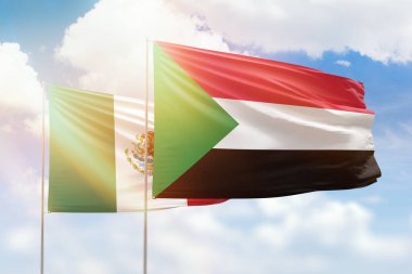 Sunny blue sky and flags of sudan and mexico