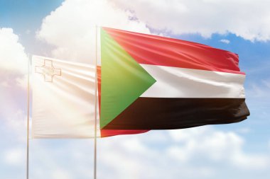 Sunny blue sky and flags of sudan and malta