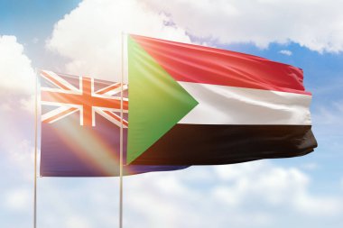 Sunny blue sky and flags of sudan and new zealand