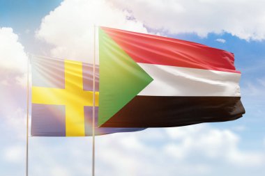 Sunny blue sky and flags of sudan and sweden