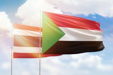 Sunny blue sky and flags of sudan and thailand