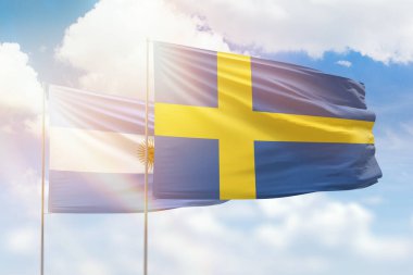 Sunny blue sky and flags of sweden and argentina